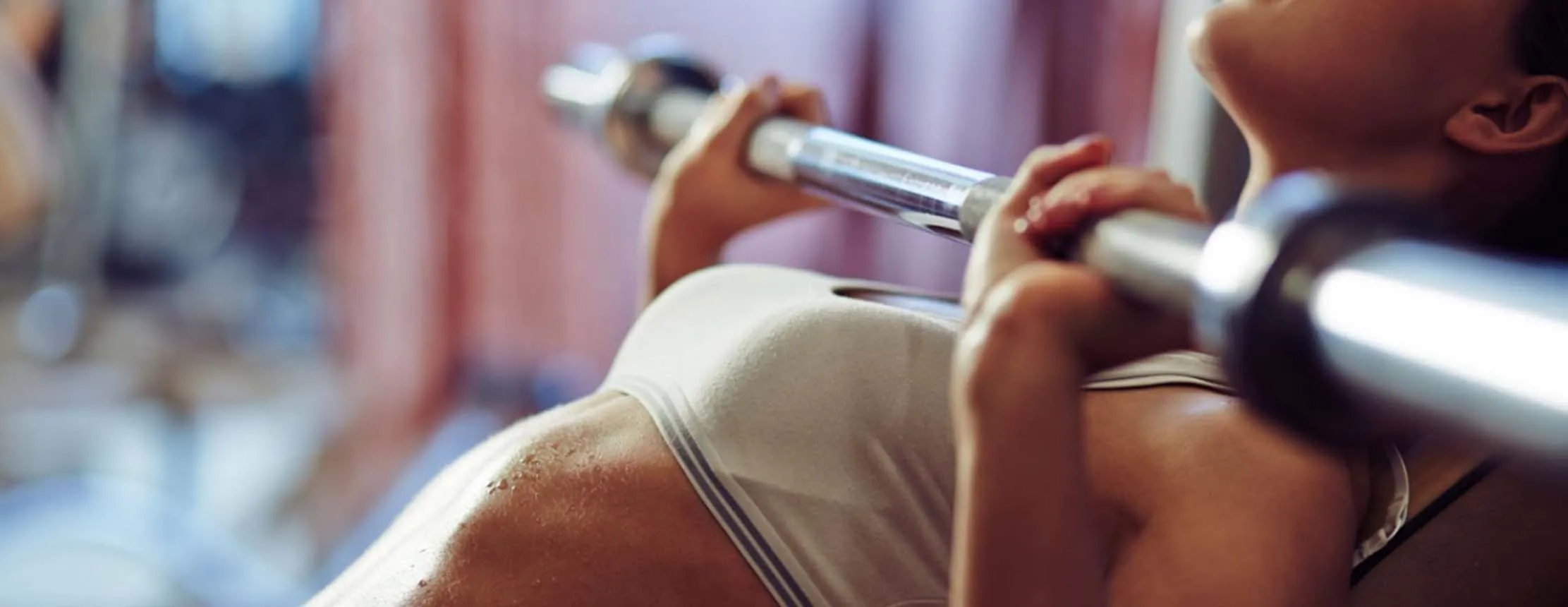 woman lifts barbell