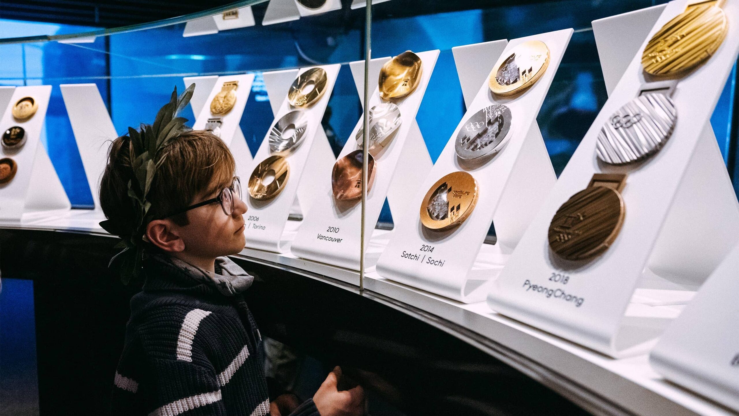 Child looks at medals in the olympic museum