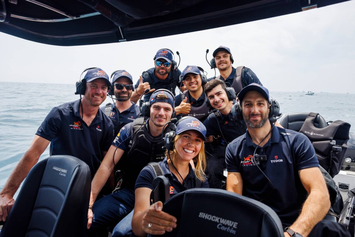 Max verstappen of the and oracle red bull racing and arnaud psarofaghis of switzerland and team members of alinghi red bull racing seen in barcelona