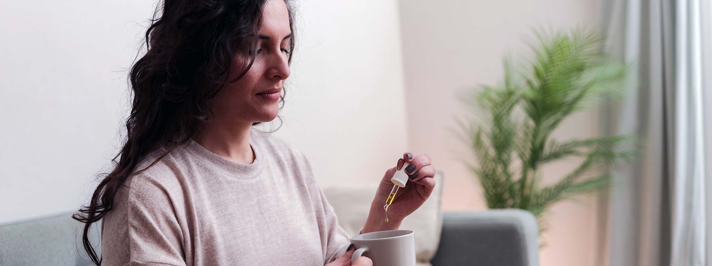 Woman taking cbd oil for anxiety treatment - vitamins and supplements