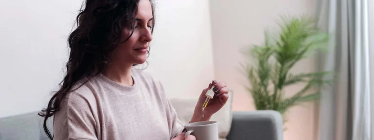 Woman taking cbd oil for anxiety treatment - Vitamins and supplements
