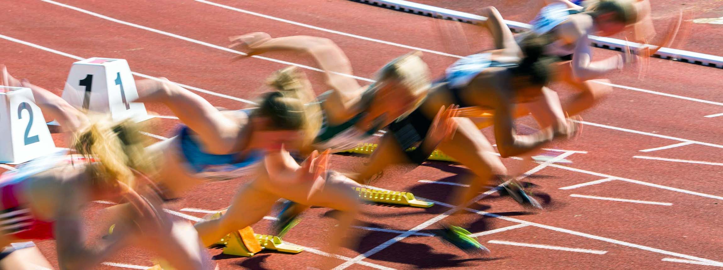 Blurred athletes on track start