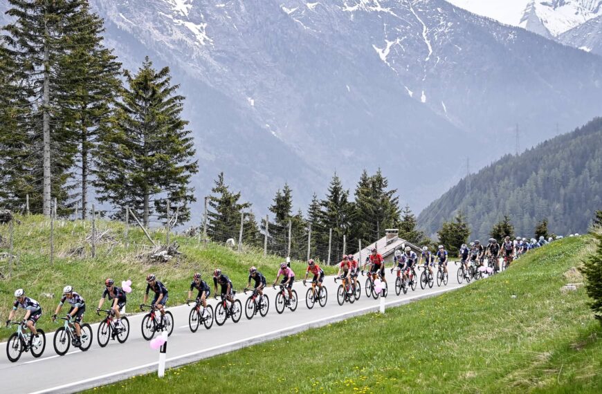 cyclists ride through the alps