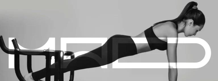 fitness woman in front of Mad Lagree signage