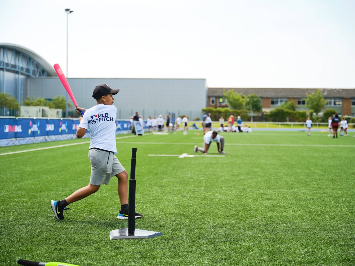 young baseball players hitting the ball