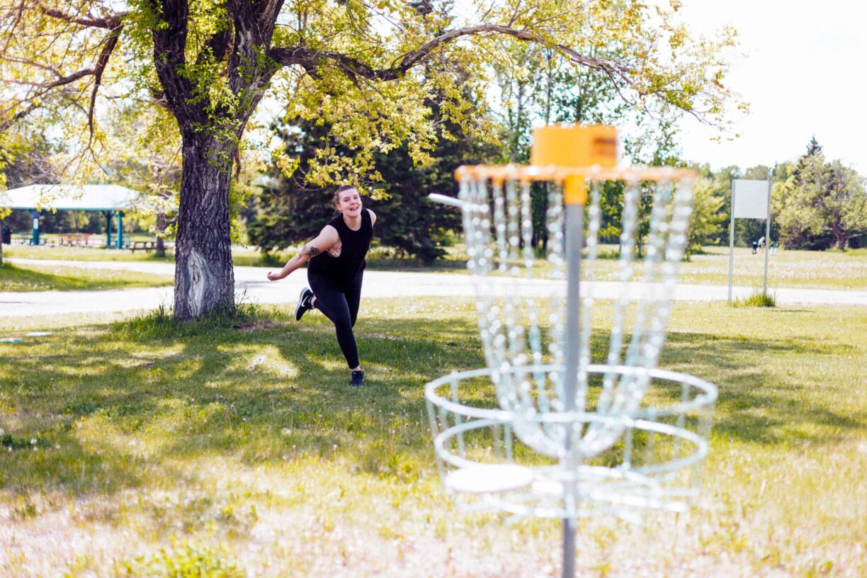 Person throwing towards a disc golf net