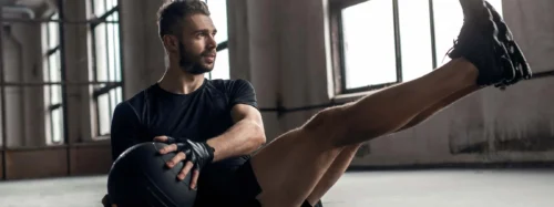 Man doing core exercise with medicine ball
