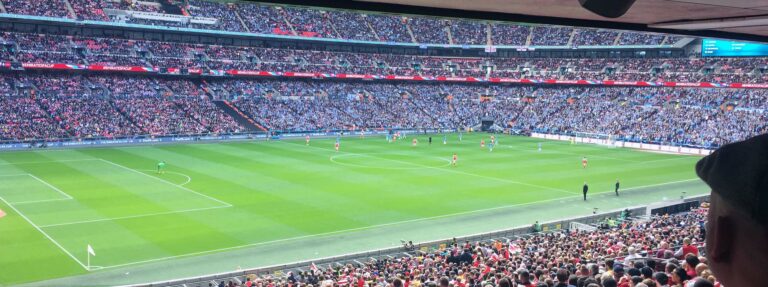 People sitting on stadium watching soccer game