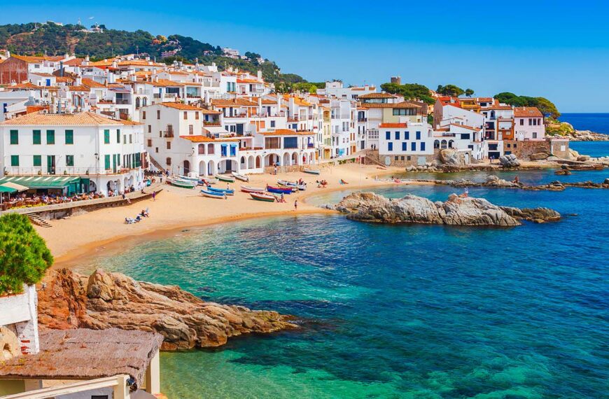 Scenic fisherman village with nice sand beach and clear blue water in nice bay. Famous tourist destination in Costa Brava