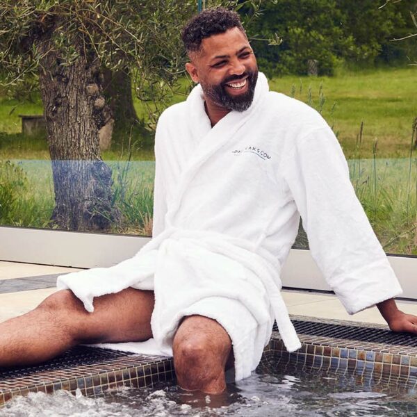 man sits at edge of spa