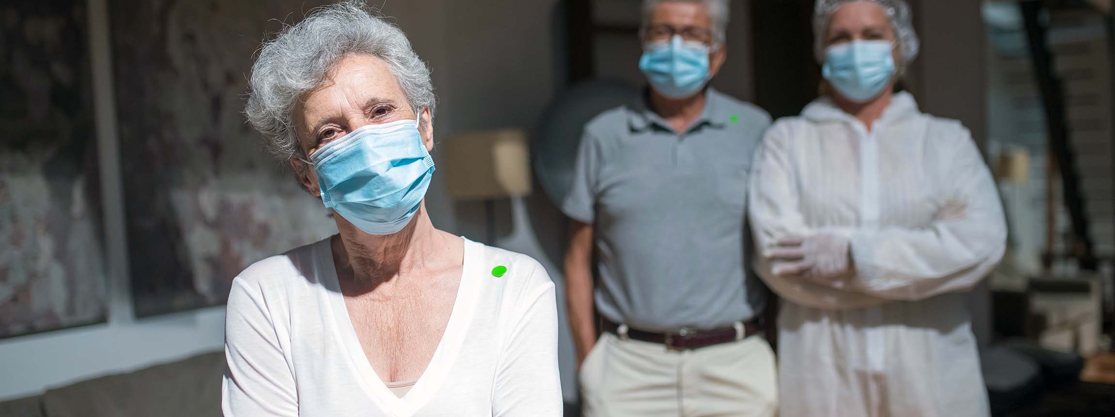 Mature people stand wearing facemasks