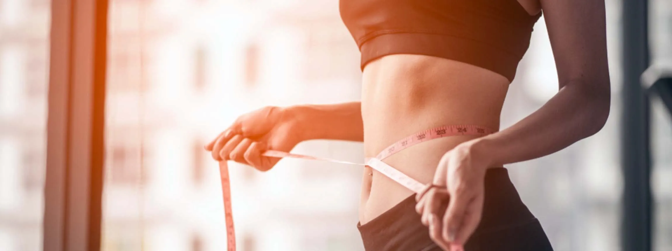 person with tape measure around waist