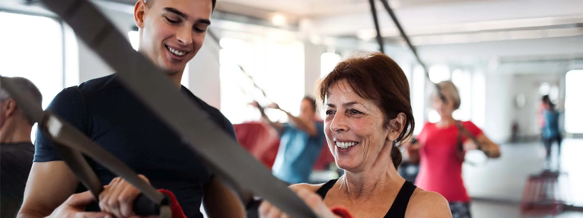 personal trainer with fitness member workout