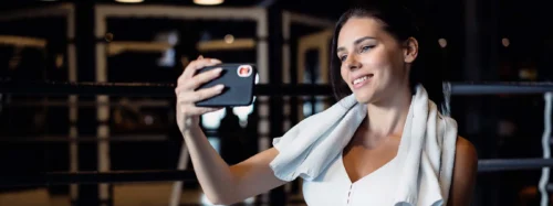 sporty woman taking selfie with mobile phone social networks