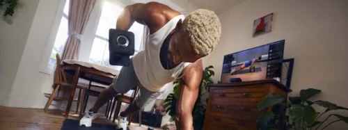 young fit guy lifts dumbbell