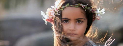 young girl wearing headress of flowers