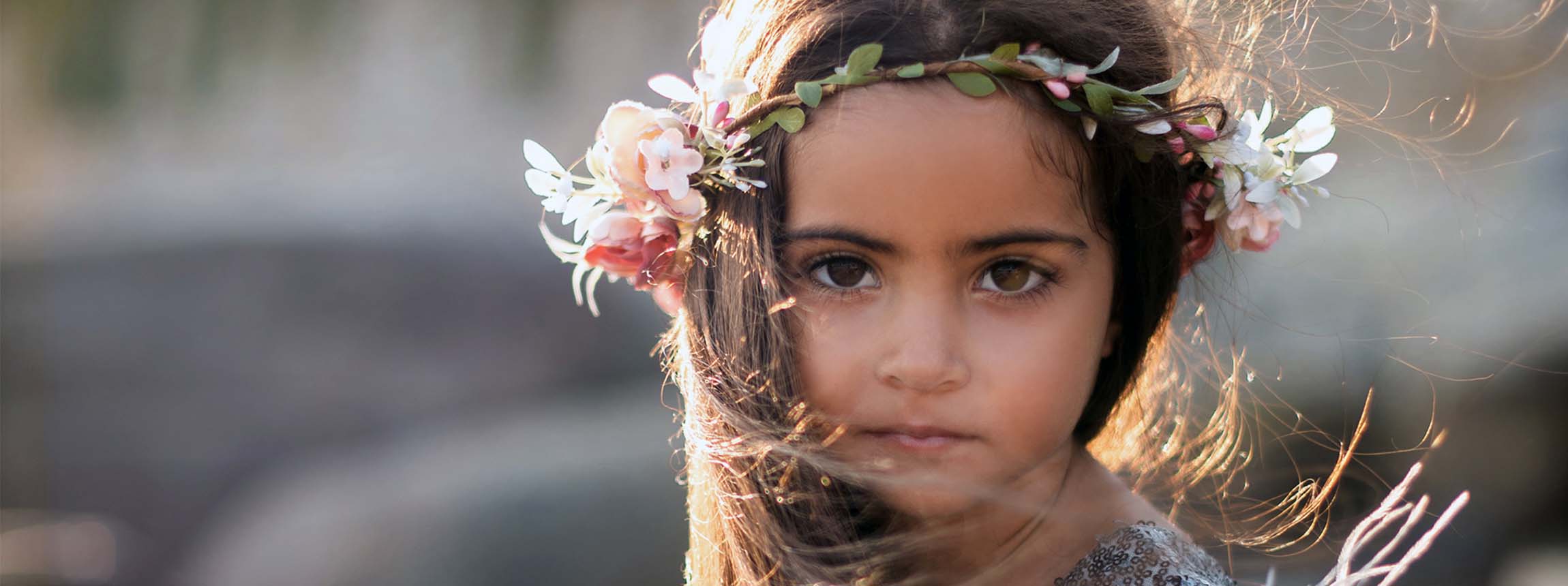 Young girl wearing headress of flowers