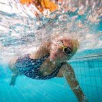 Underwater shot of woman swimming front crawl