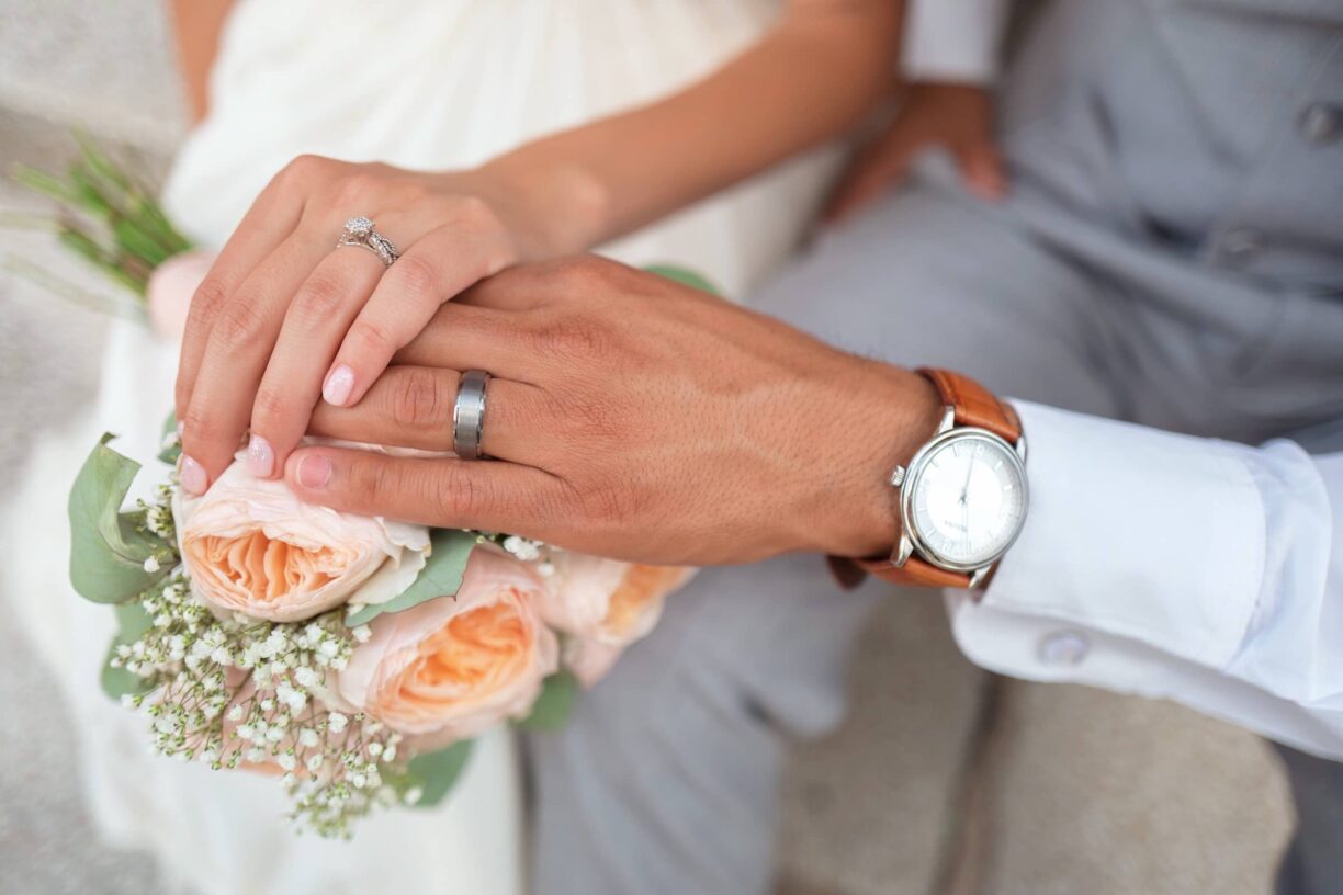 Couple hold hands after being married