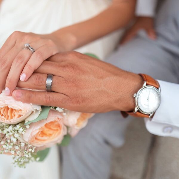 couple hold hands after being married