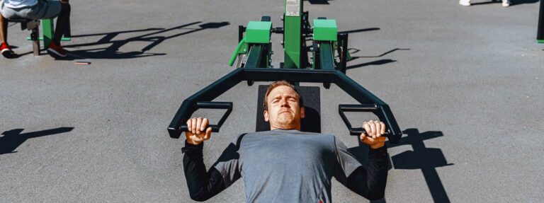 man works out in public park