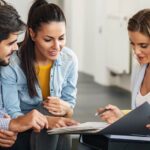 Female professional offering insurance to young couple