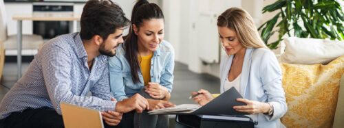 Female professional offering insurance to young couple