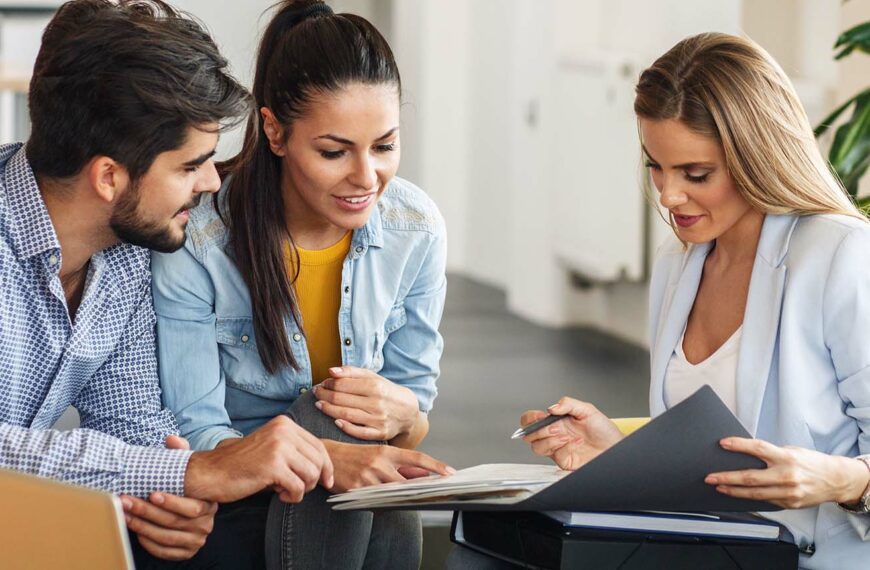 Female professional offering insurance to young couple