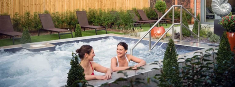 women enjoy talking in swimming pool