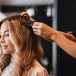 A hairdresser styling a client's hair in a salon