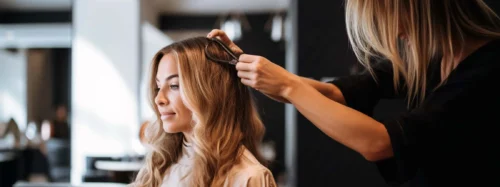 A hairdresser styling a client's hair in a salon