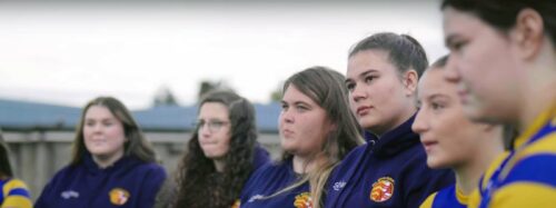 Rugby Women in line listen to coach talk
