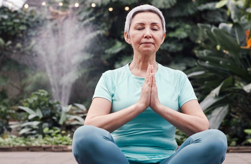 Senior woman sits in yoga position