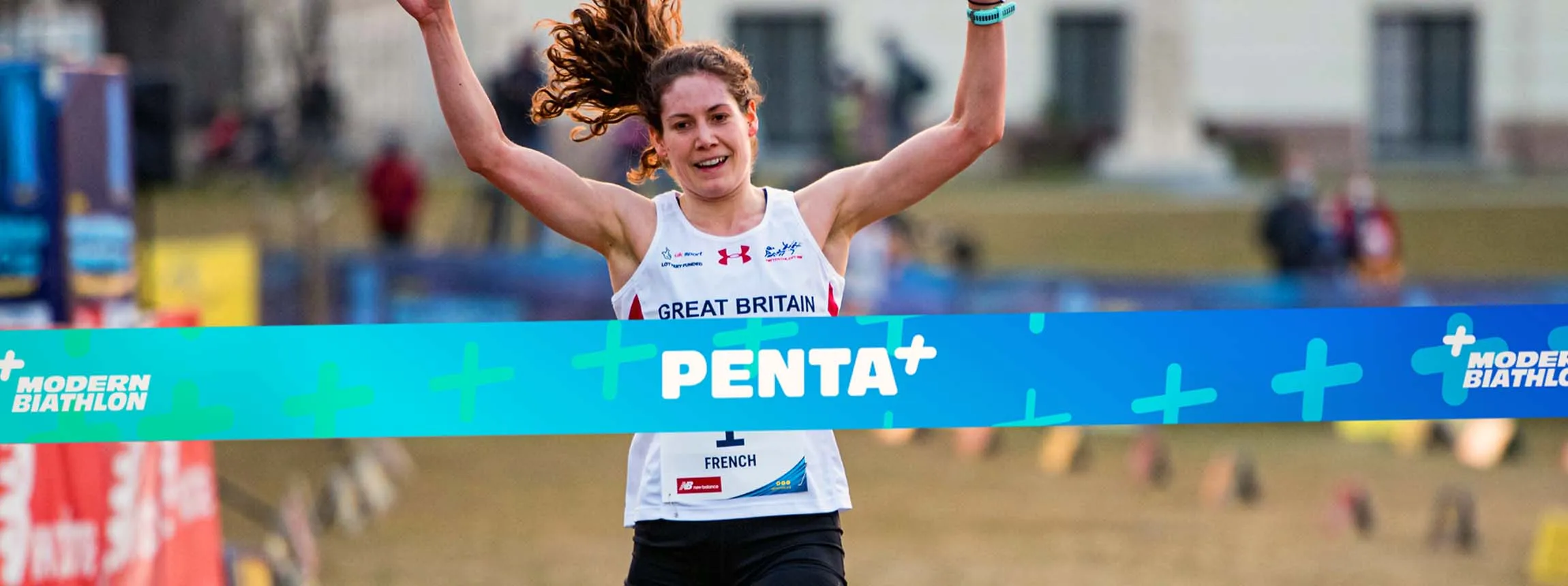 athlete crosses penta+ finish line