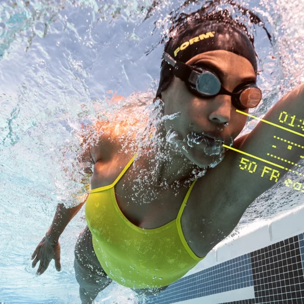 swimmer swimming with headcoach goggles