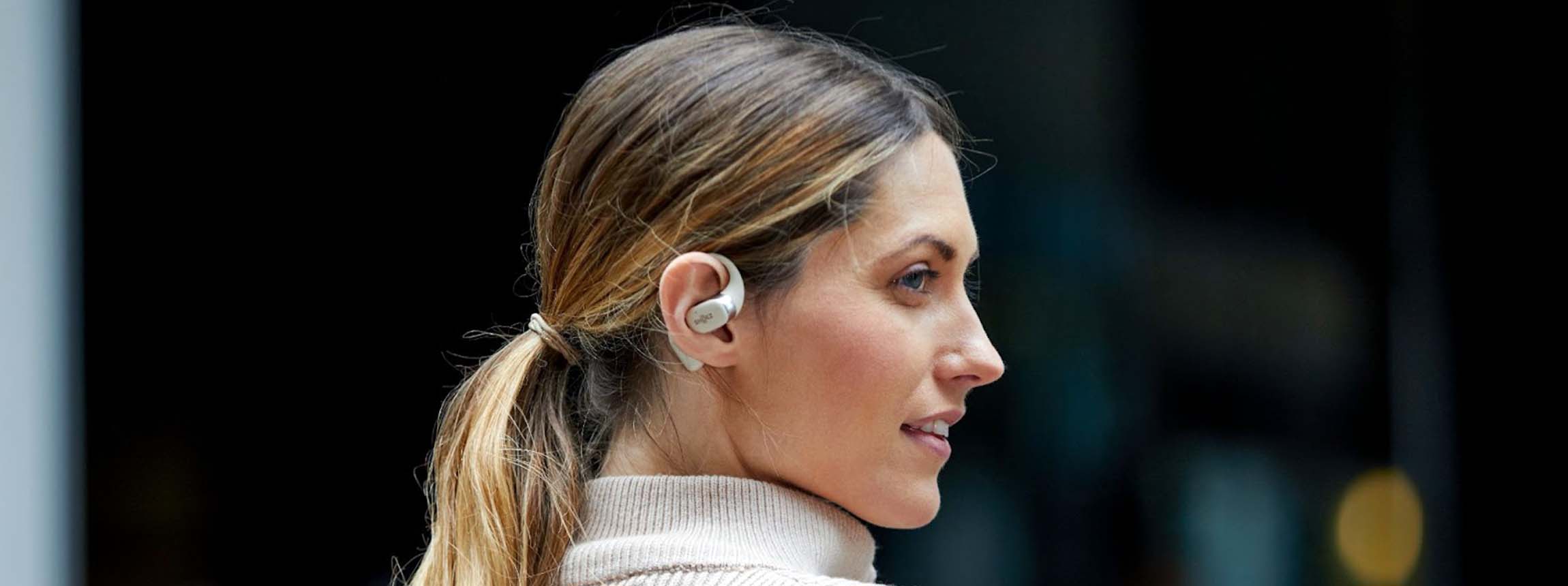 Woman wearing shokz wireless earbuds