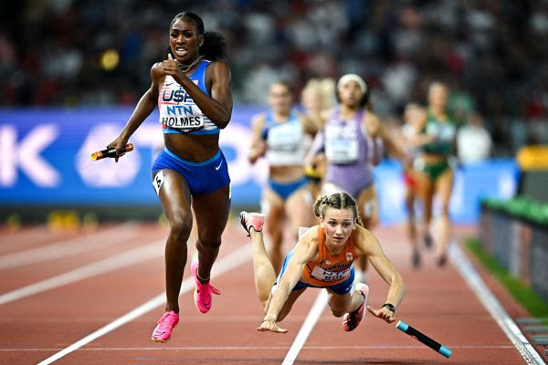 Alexis Holmes of USA, left, on her way to winning the mixed 4x400m as Femke Bol of Netherlands falls