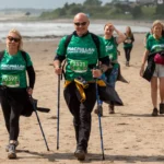 Macmillan Mighty Hikers walk across beach