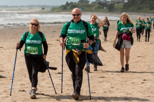 Macmillan Mighty Hikers walk across beach