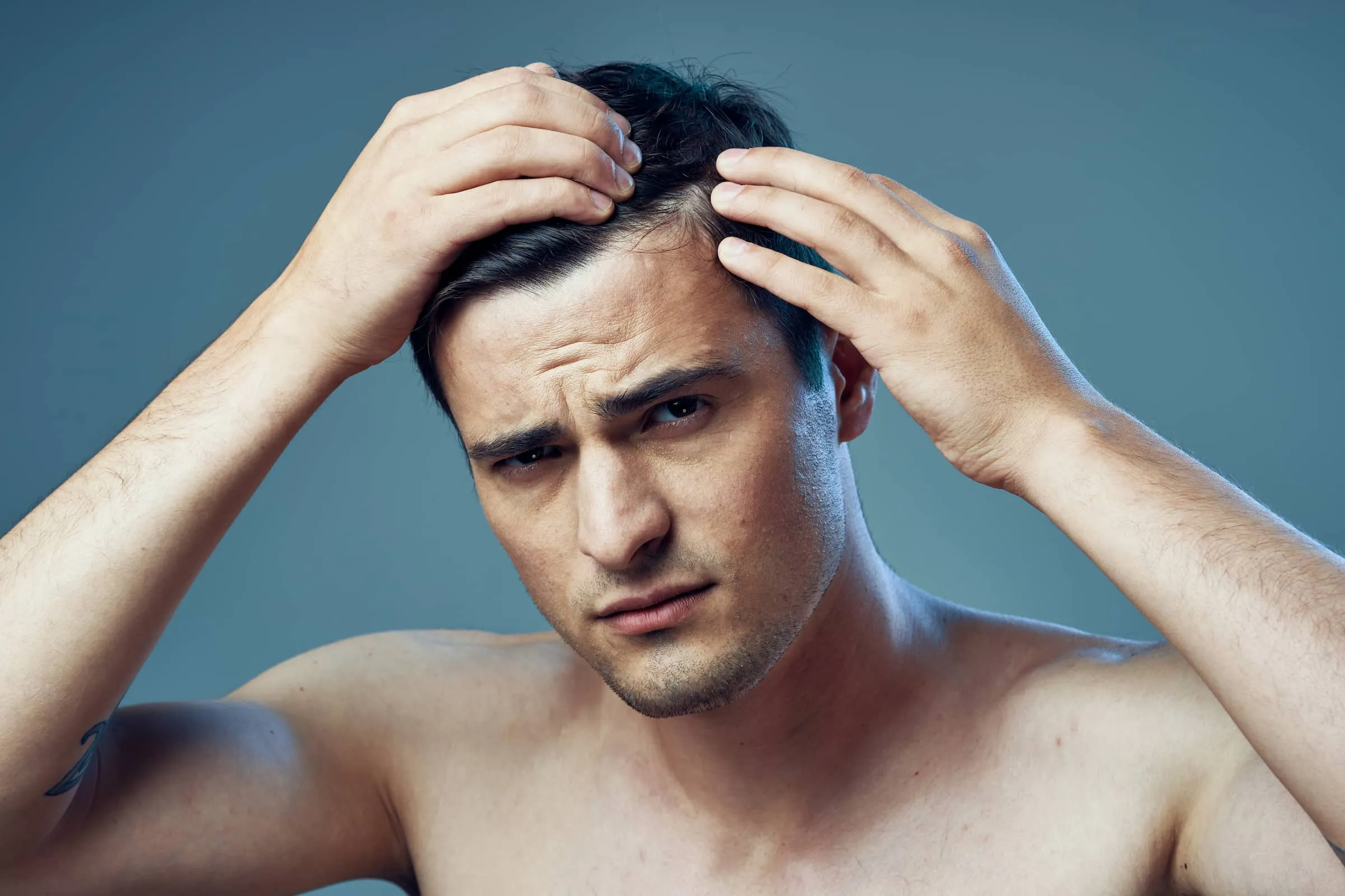 Young man checking hairline