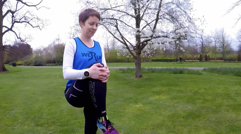 Woman in park stretches