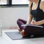 Yoga woman writing in her notebook