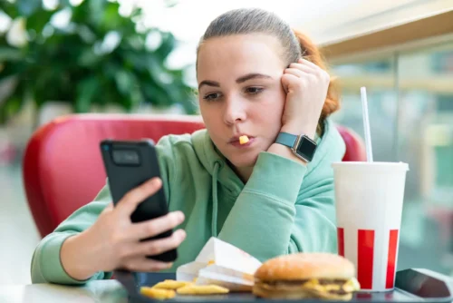 bored girl eating fast junk food