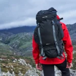 Hiker in mountains wearing rucksack