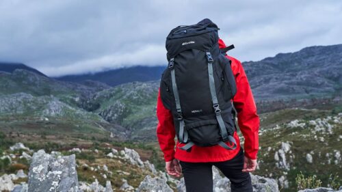 Hiker in mountains wearing rucksack