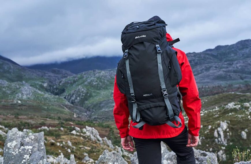 Hiker in mountains wearing rucksack