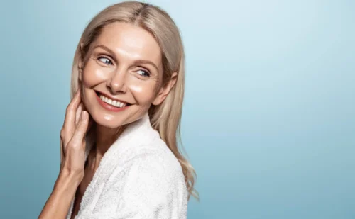mid aged mature woman looking away isolated on blue