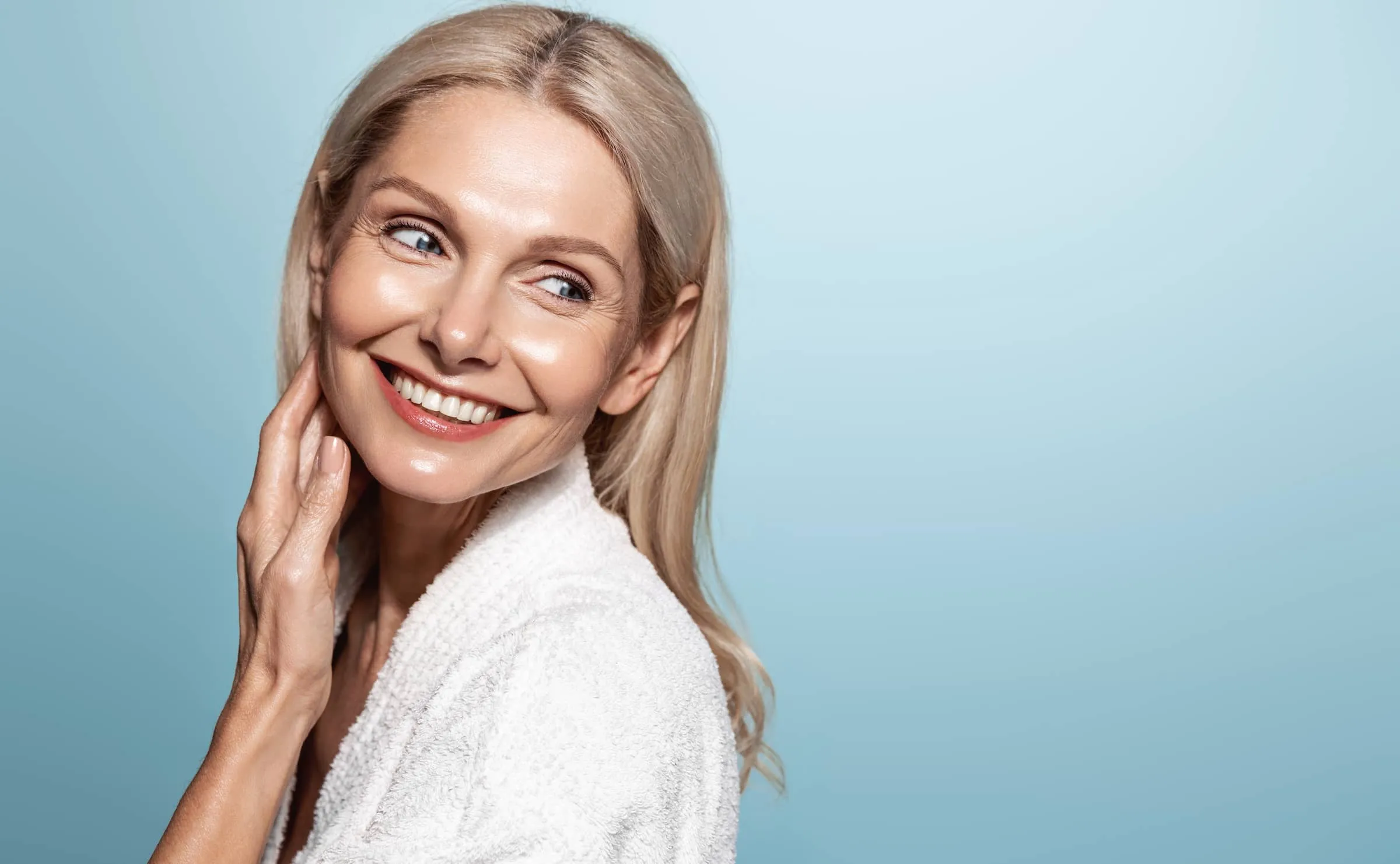 mid aged mature woman looking away isolated on blue