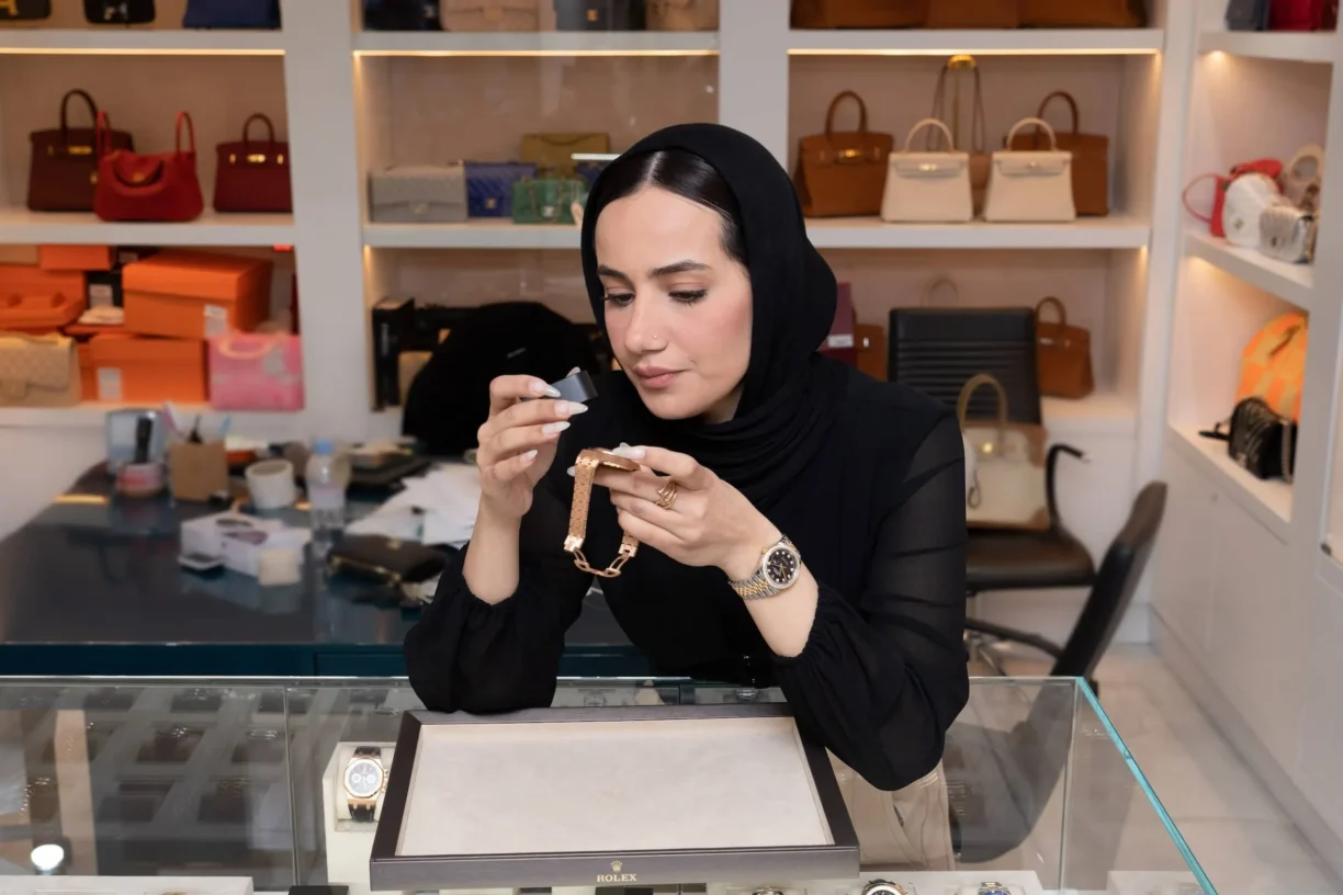 Horologist Marya Ali examines a watch