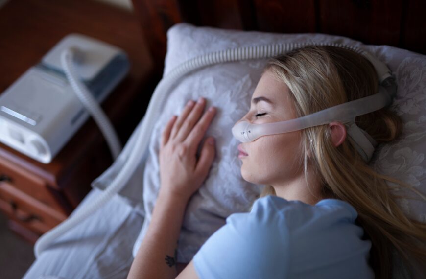 Young person, sleeping with cpap machine.